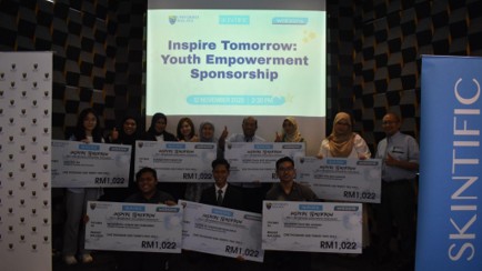 Mock cheque presentation to students.